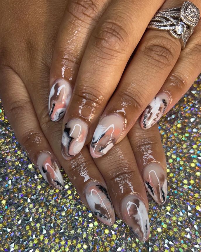 Hand-painted acrylic nail art on a holographic backdrop