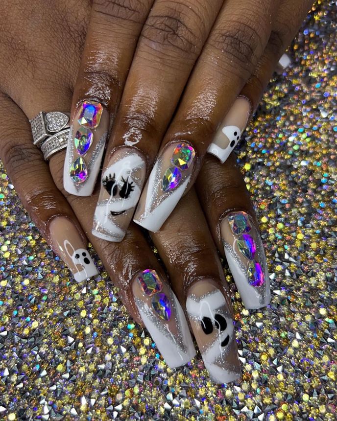 Hand-painted acrylic nail art on a holographic backdrop