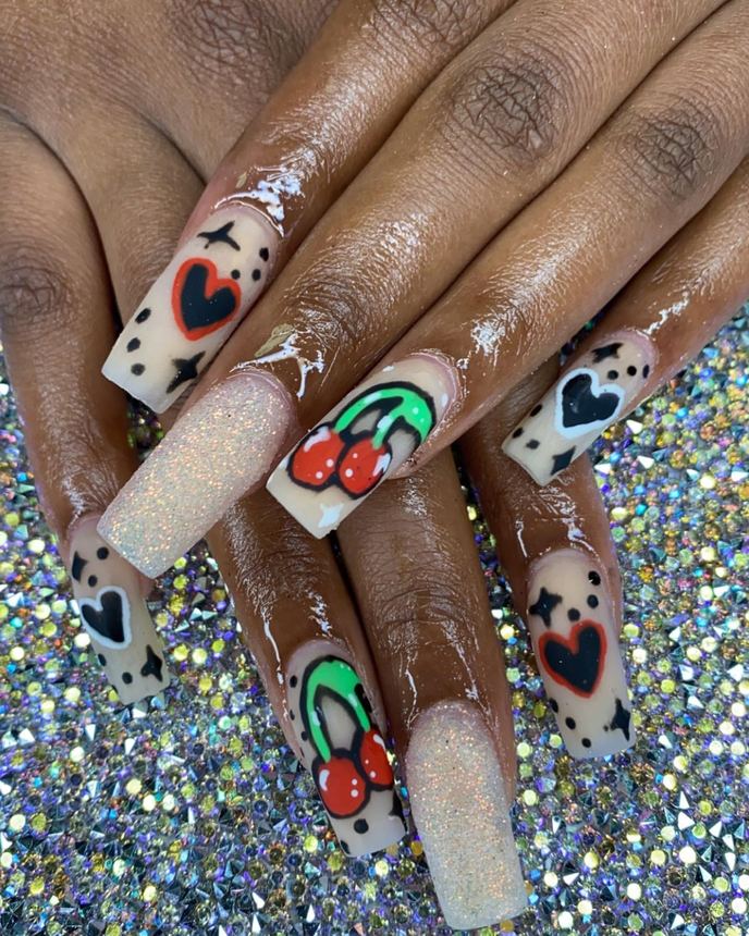 Hand-painted acrylic nail art on a holographic backdrop