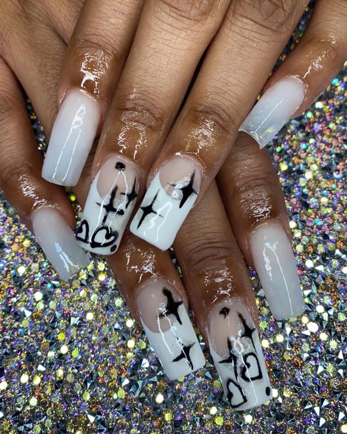 Hand-painted acrylic nail art on a holographic backdrop