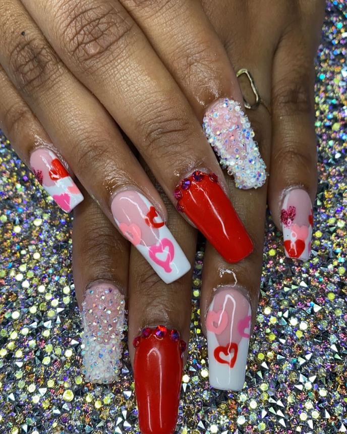 Hand-painted acrylic nail art on a holographic backdrop