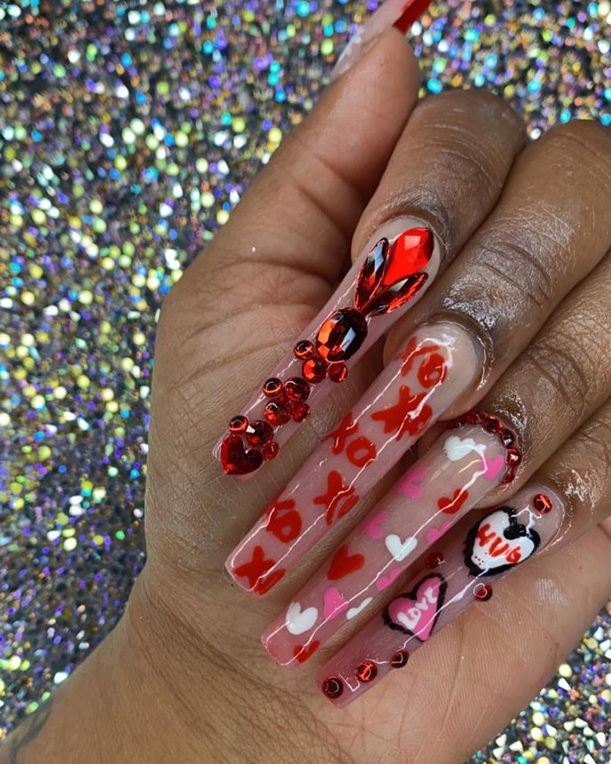 Hand-painted acrylic nail art on a holographic backdrop