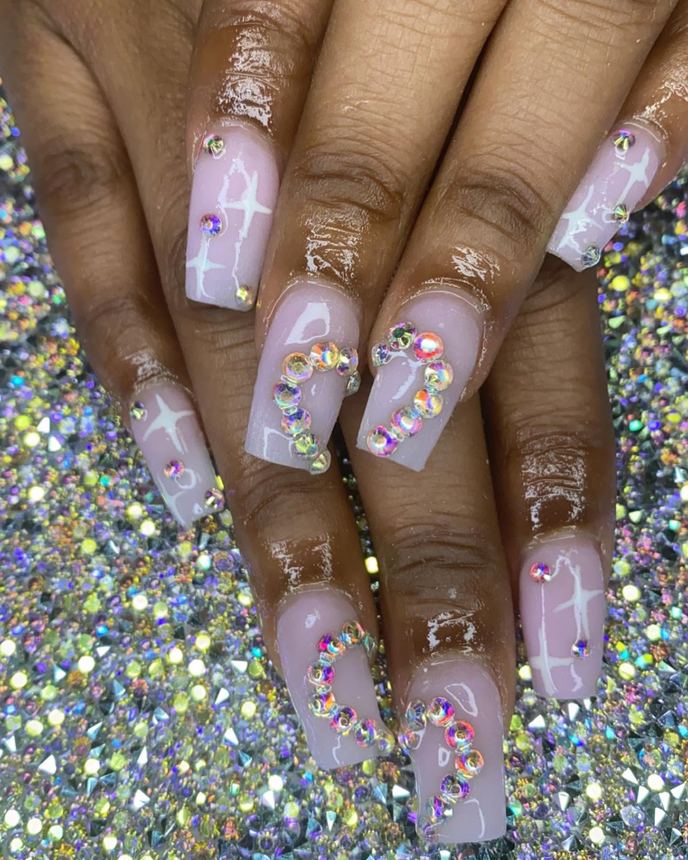 Hand-painted acrylic nail art on a holographic backdrop