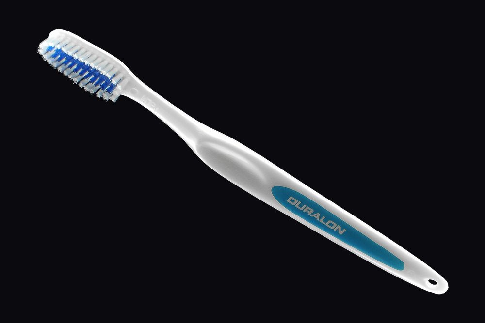 A toothbrush lying on a plain surface