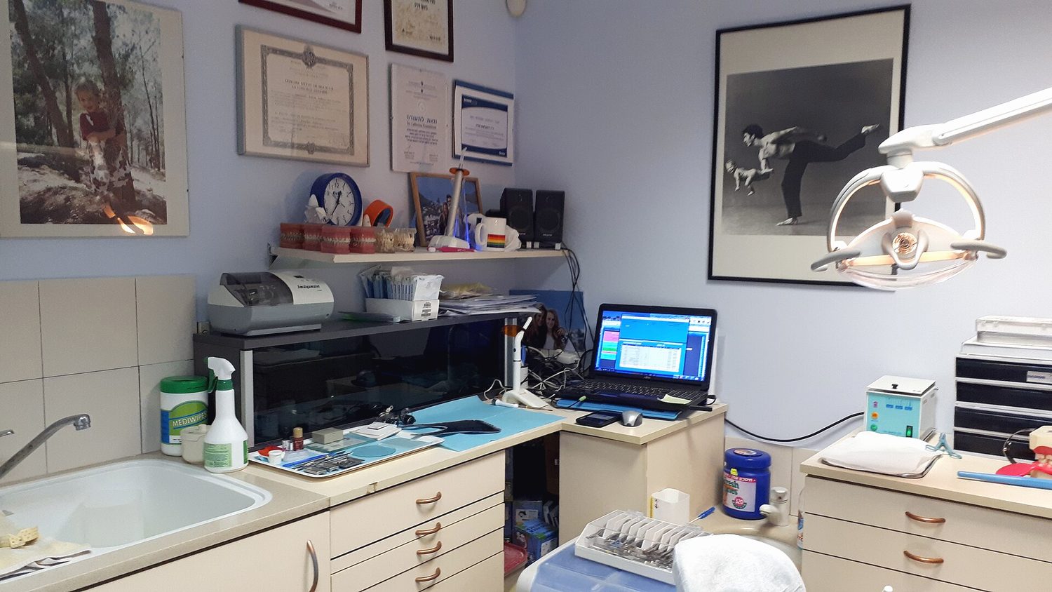 A dental surgery with a chair, equipment and a window